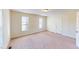 Well-lit bedroom with two windows and a door at 308 E First St, Princeton, NC 27569