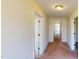 Long hallway with light beige walls and carpeted floor at 308 E First St, Princeton, NC 27569