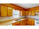 Kitchen with wood cabinets, tile floors, and a window above the sink at 308 E First St, Princeton, NC 27569