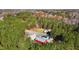 Aerial view of property showing house, red barn, and wooded area at 3214-3220 Tump Wilkins Rd, Stem, NC 27581