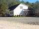 Two-story white house with gravel driveway at 3214-3220 Tump Wilkins Rd, Stem, NC 27581