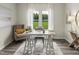 Home office with a white desk, gray armchair, and a view of the backyard at 332 Squirrel Oaks Ln, Garner, NC 27529