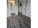 View of bedroom with gray floors and a glimpse of the bathroom vanity at 409 Granville St, Oxford, NC 27565