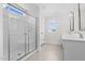 Modern bathroom featuring double vanity, white cabinets and a large shower at 41 Red River Dr, Selma, NC 27576