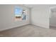 Bright bedroom featuring a window with wooded views and carpet at 41 Red River Dr, Selma, NC 27576