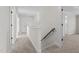 Upstairs hallway with carpet and doors to bedrooms at 41 Red River Dr, Selma, NC 27576