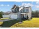 Two-story house with gray siding, two-car garage and landscaping at 41 Red River Dr, Selma, NC 27576
