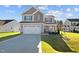 Two-story house with gray siding, two-car garage at 41 Red River Dr, Selma, NC 27576