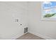 Bright laundry room with shelving and window at 41 Red River Dr, Selma, NC 27576