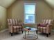 Relaxing sitting area with two striped armchairs at 412 Airedale Trl, Garner, NC 27529