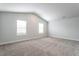 Spacious bedroom with vaulted ceiling, carpet, and two windows at 502 Azalea Gaze Dr, Youngsville, NC 27596