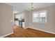 Dining area with hardwood floors and a chandelier, adjacent to the kitchen at 502 Lemontree Ct, Graham, NC 27253