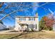 Two-story house with beige siding, a brick chimney, and a landscaped lawn at 502 Lemontree Ct, Graham, NC 27253