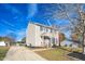 Two-story house with beige siding, a brick chimney, and a landscaped lawn at 502 Lemontree Ct, Graham, NC 27253