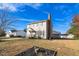 Two-story house with beige siding, a brick chimney, and a landscaped lawn at 502 Lemontree Ct, Graham, NC 27253