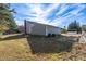 Two-story house with gray siding, detached garage, and a yard with garden at 502 Lemontree Ct, Graham, NC 27253