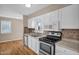 Well-equipped kitchen boasting white cabinets, tile backsplash and stainless steel appliances at 502 Lemontree Ct, Graham, NC 27253