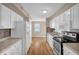 Modern kitchen offering white cabinets, granite countertops, and stainless steel appliances at 502 Lemontree Ct, Graham, NC 27253