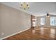 Bright living room featuring hardwood floors, a brick fireplace, and a ceiling fan at 502 Lemontree Ct, Graham, NC 27253