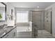 Bathroom with soaking tub and walk-in shower with glass enclosure at 712 Apple Churn Dr, Fuquay Varina, NC 27526