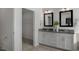 Double vanity bathroom with large mirrors and walk-in closet at 712 Apple Churn Dr, Fuquay Varina, NC 27526