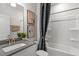 Clean bathroom with a shower/tub combo, gray vanity, and modern fixtures at 712 Apple Churn Dr, Fuquay Varina, NC 27526