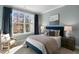 Comfortable bedroom with a plush bed, large windows, and plenty of natural light at 712 Apple Churn Dr, Fuquay Varina, NC 27526