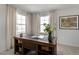 Bright home office features a large desk, built-in shelving, and plenty of natural light at 712 Apple Churn Dr, Fuquay Varina, NC 27526