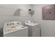 Laundry room with Whirlpool washer and dryer, and shelving at 712 Apple Churn Dr, Fuquay Varina, NC 27526