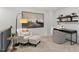 Cozy loft area with a comfortable armchair, a desk, and built-in shelving at 712 Apple Churn Dr, Fuquay Varina, NC 27526