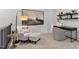 Bright loft features a desk, comfortable armchair and a large painting at 720 Apple Churn Dr, Fuquay Varina, NC 27526