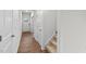 Bright hallway with wood-look flooring and access to stairs at 7549 Michelle Rd, Rocky Mount, NC 27803