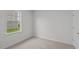 Bright bedroom with carpeted floors and a large window at 7586 Michelle Rd, Rocky Mount, NC 27803