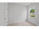 Simple bedroom with neutral wall and carpet, offering a closet and a window at 7586 Michelle Rd, Rocky Mount, NC 27803