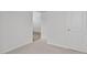 Small bedroom with carpet and neutral walls, offering two closets and a view at 7586 Michelle Rd, Rocky Mount, NC 27803