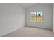 Spacious bedroom with a large window and carpeted floor at 7586 Michelle Rd, Rocky Mount, NC 27803