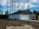 Side view of a two-story house showcasing a two-car garage and gray siding at 7586 Michelle Rd, Rocky Mount, NC 27803