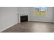 Living room featuring a fireplace and large window at 7586 Michelle Rd, Rocky Mount, NC 27803