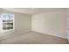 Simple bedroom with carpet flooring and a window at 7622 Michelle Rd, Rocky Mount, NC 27803