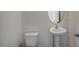 Small powder room with pedestal sink and oval mirror at 7622 Michelle Rd, Rocky Mount, NC 27803