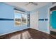 Bright bedroom with wood-look floors, ceiling fan, and a large window at 89 Sandy Bluff Ct, Sanford, NC 27332