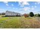 Back of house with wooden deck and large yard at 89 Sandy Bluff Ct, Sanford, NC 27332