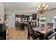 Kitchen with dark cabinets, an island, and dining area at 906 Collington Dr, Mebane, NC 27302