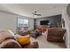 Cozy living room featuring brown leather furniture and a large TV at 906 Collington Dr, Mebane, NC 27302