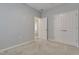 Bright bedroom with neutral walls, carpet, and double door closet at 1008 Tuscarora Ln, Durham, NC 27703