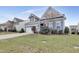 Gray two-story house with white garage door, landscaping, and American flag at 1008 Tuscarora Ln, Durham, NC 27703