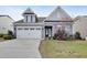 Gray two-story house with white garage door and landscaping at 1008 Tuscarora Ln, Durham, NC 27703