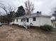 White sided house with a side view of the home, showcasing a stairway at 1015 Cross Link Rd, Raleigh, NC 27610