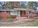 Brick front of house with porch and landscaping at 102 S 2Nd St, Micro, NC 27555