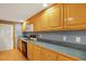 Kitchen with wood cabinets, blue walls and gas range at 102 S 2Nd St, Micro, NC 27555